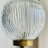 Floor lamp in gilded brass and round glass globe