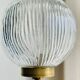 Brass floor lamp with a round glass globe