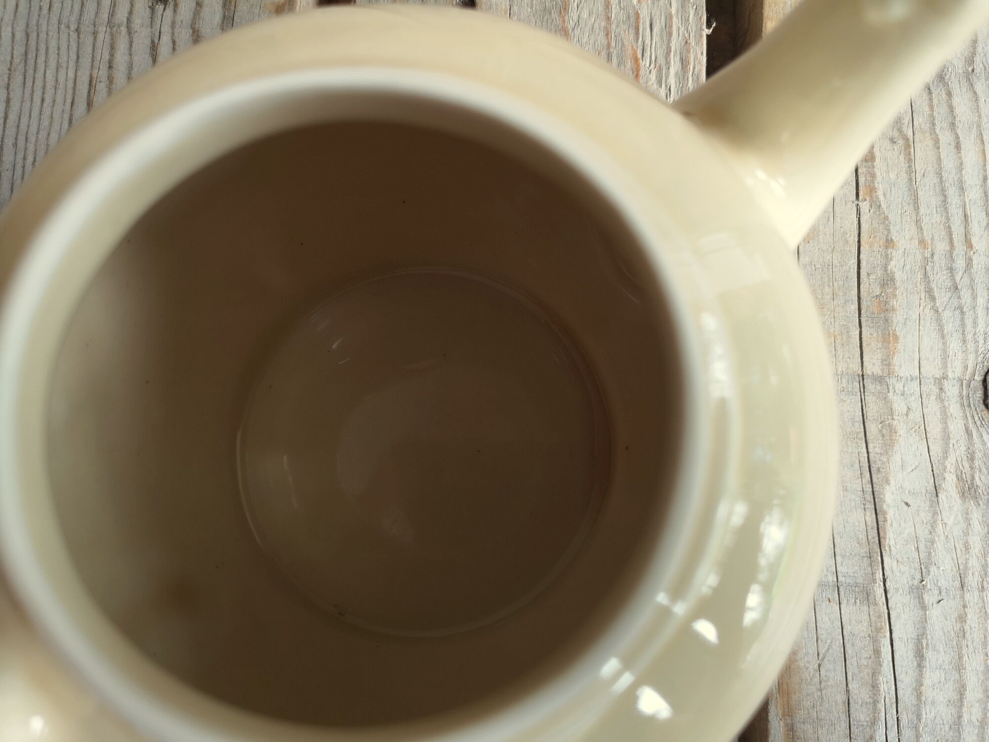 Little ancient teapot in ceramics color cream