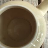 Little ancient teapot in ceramics color cream