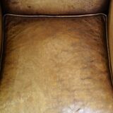 Sheepskin wingback chair with a unique design and a beautiful patina