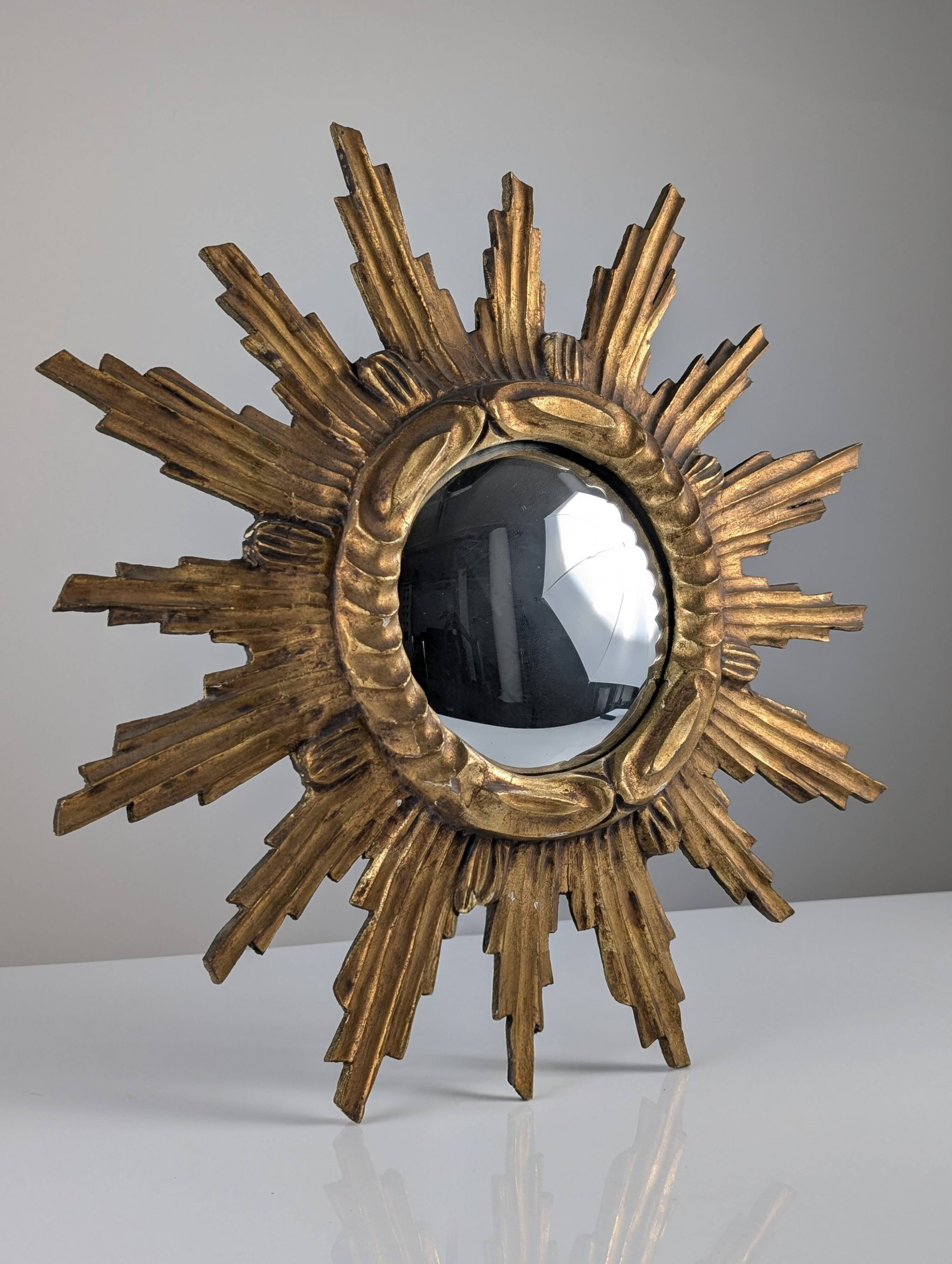 Convex sunburst mirror in carved and gilded wood, 1950s