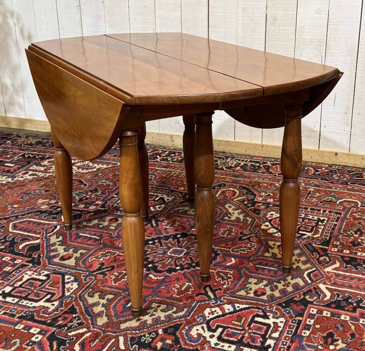 Round cherry wood table, 6 feet, Louis Philippe style with 2 extensions.