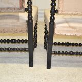 Pair of low armchairs in blackened wood