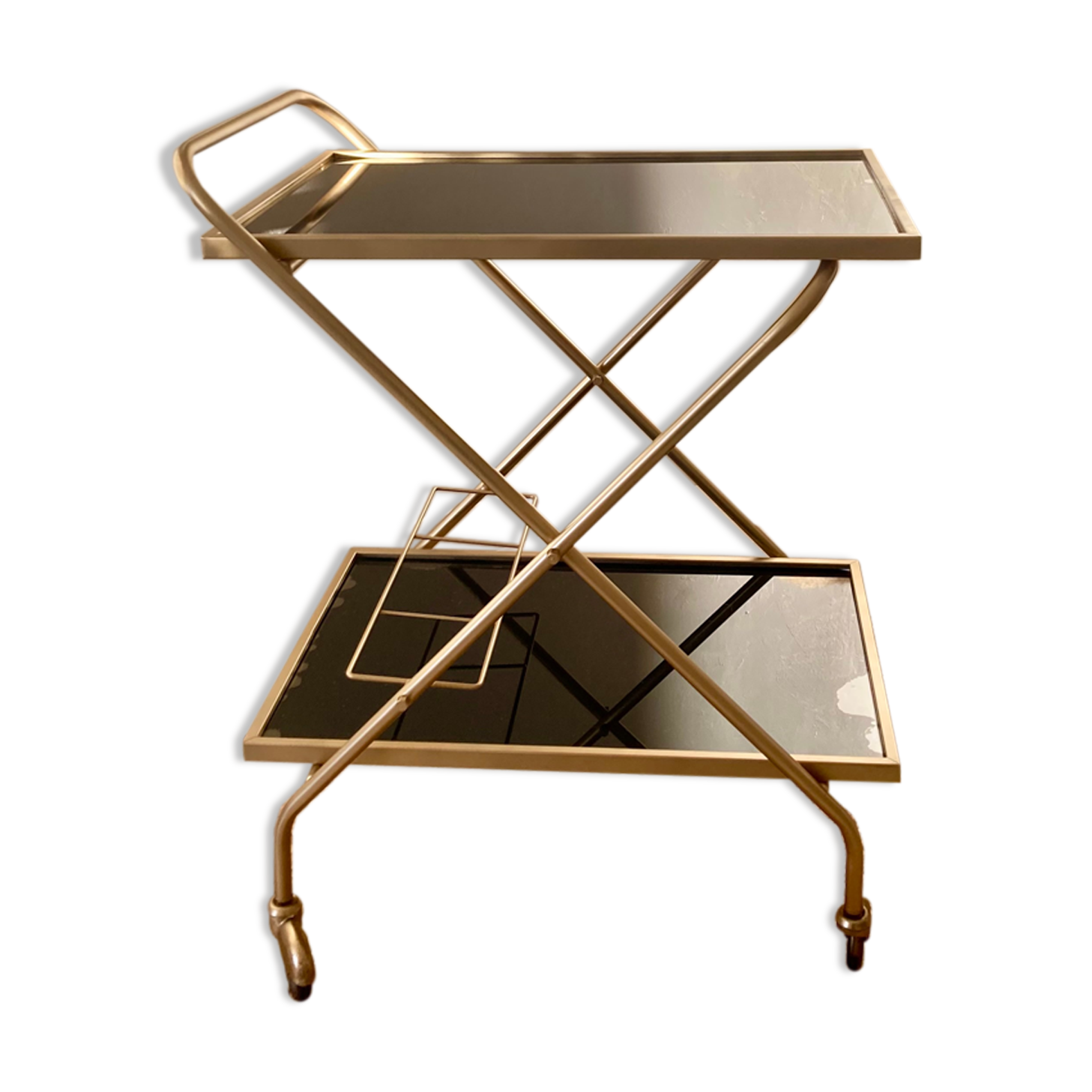 Golden dessert on wheels with black glass trays