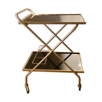 Golden dessert on wheels with black glass trays