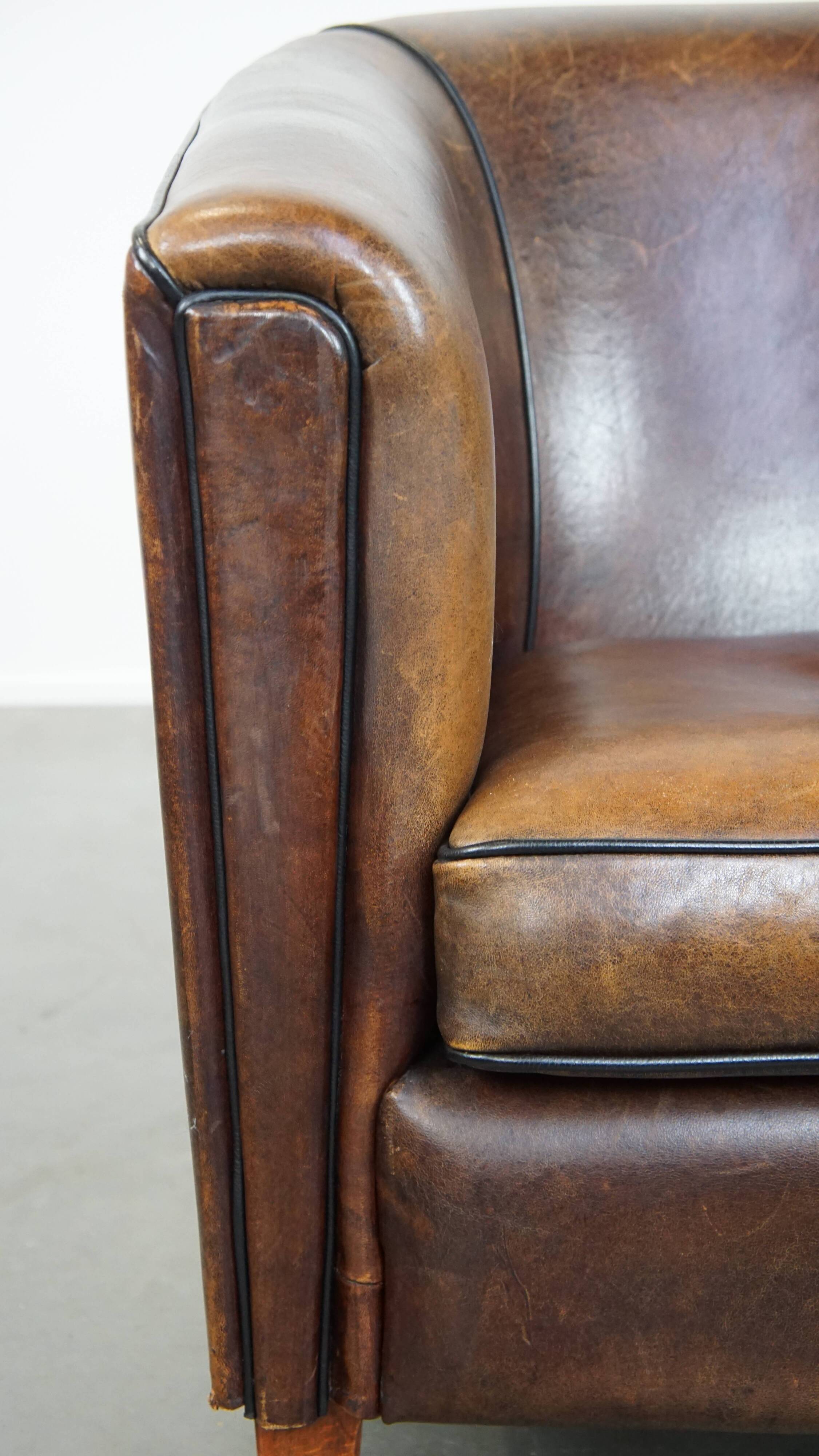 Sheep leather club chair finished with black piping