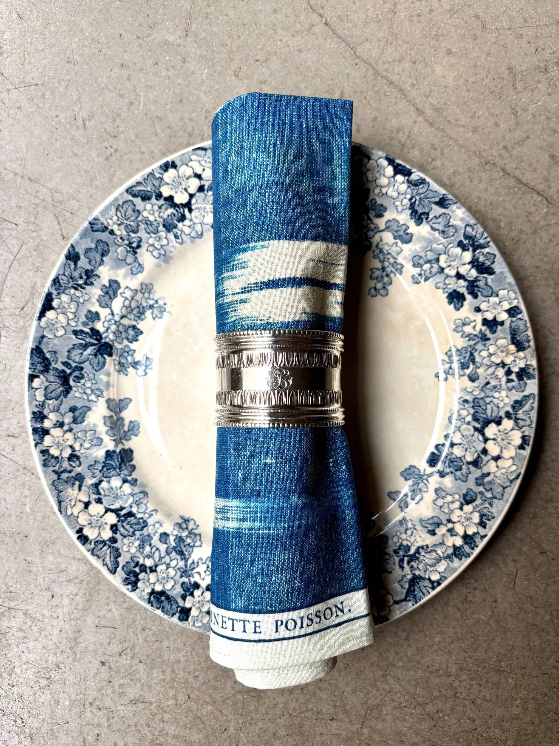 Monogrammed silver napkin ring with palmette and beaded motifs