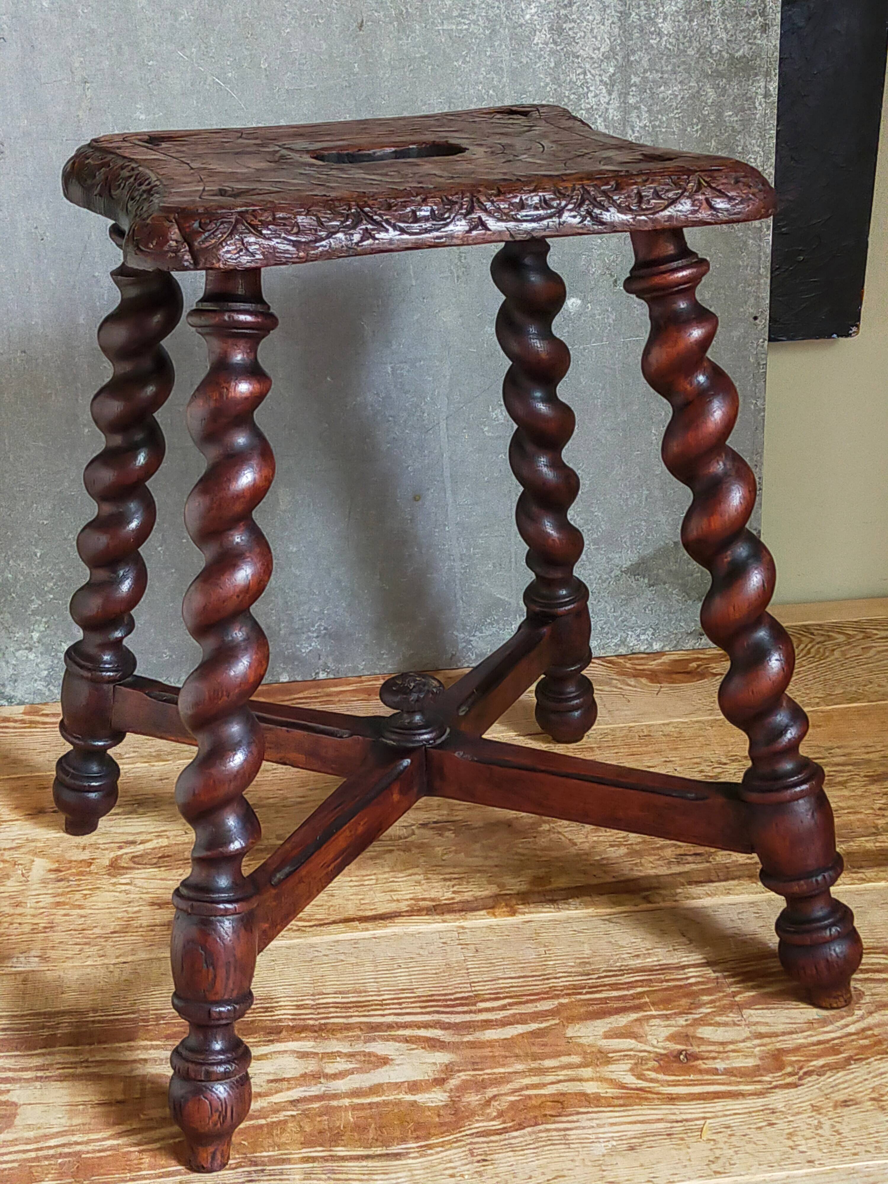 Antique stool in turned and carved solid wood