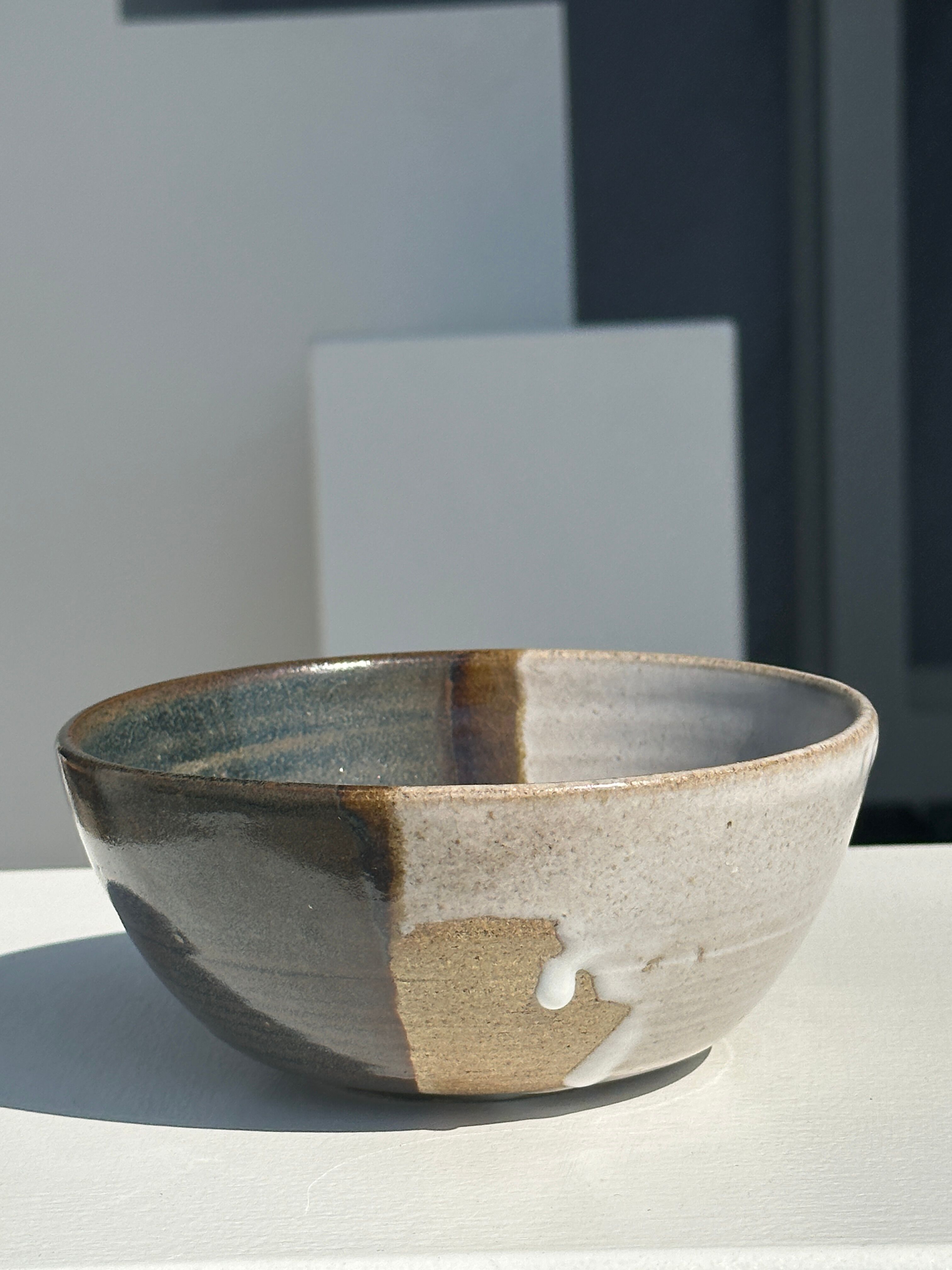White and glossy brown two-tone ceramic bowl, matt earth