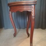 Half-moon mahogany game table on casters