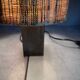 Small modernist table lamp with hand-woven shade.