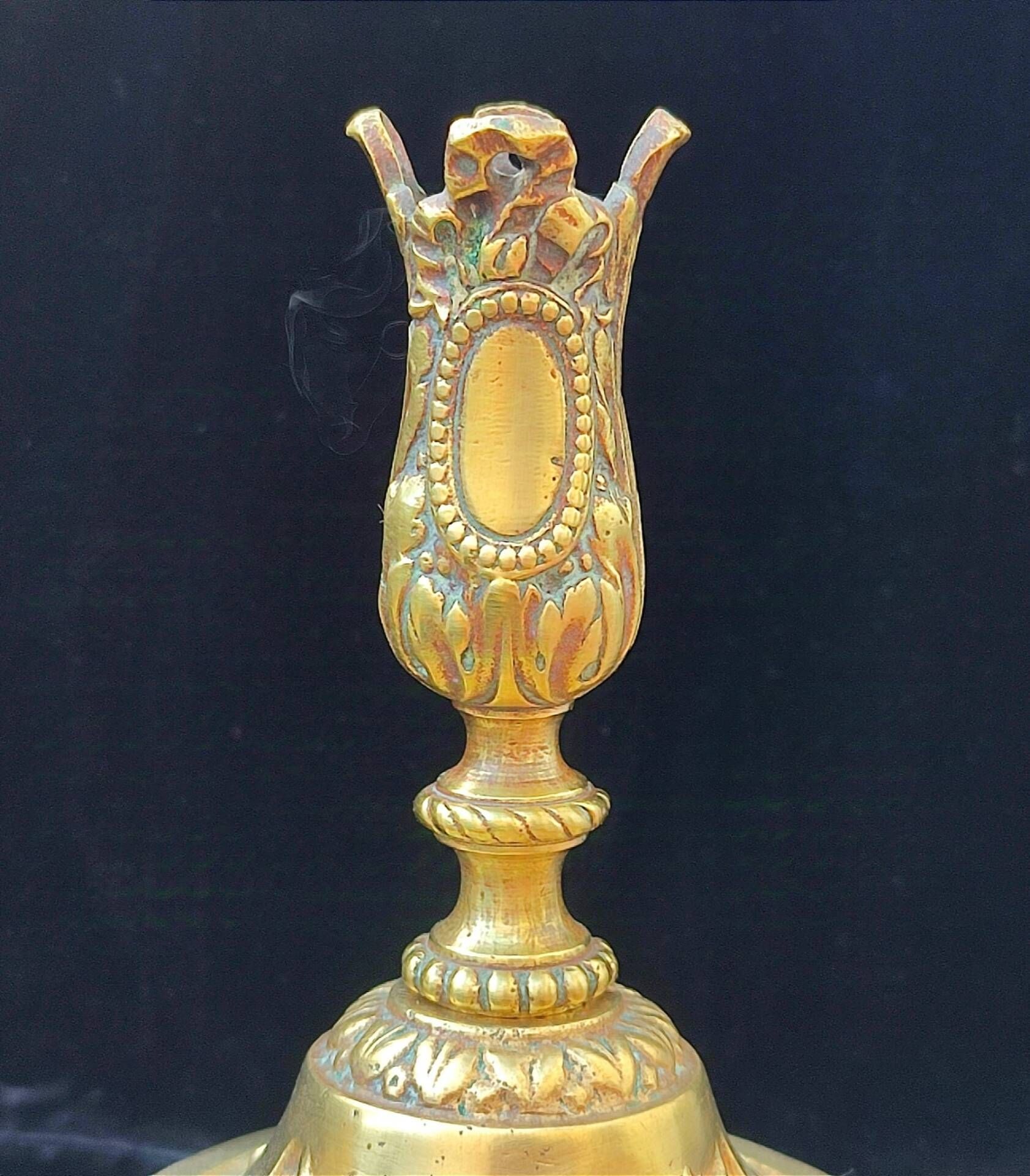 Pair of antique carved bronze candlesticks.