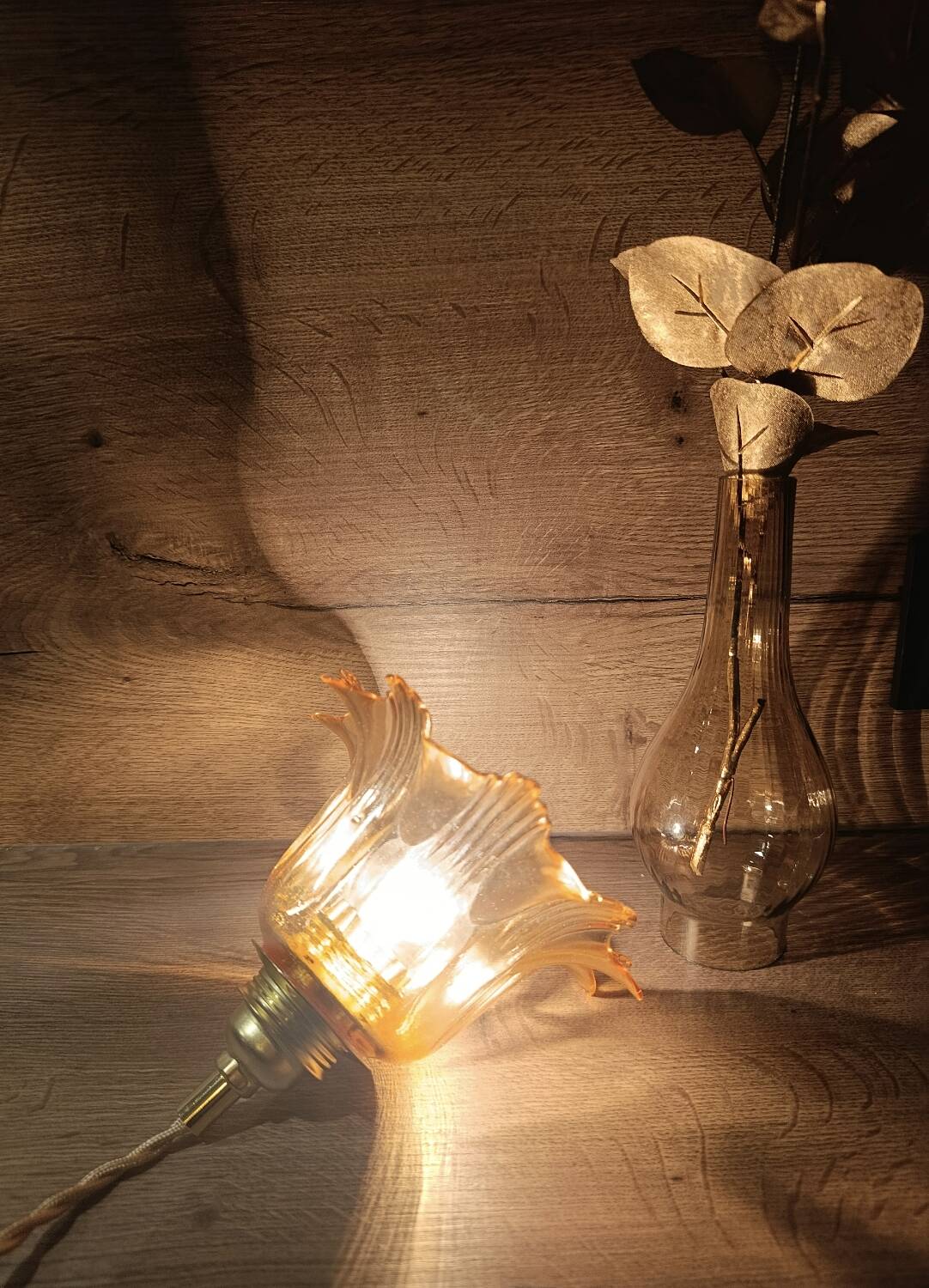 Amber tulip glass portable lamp, golden braided cord.