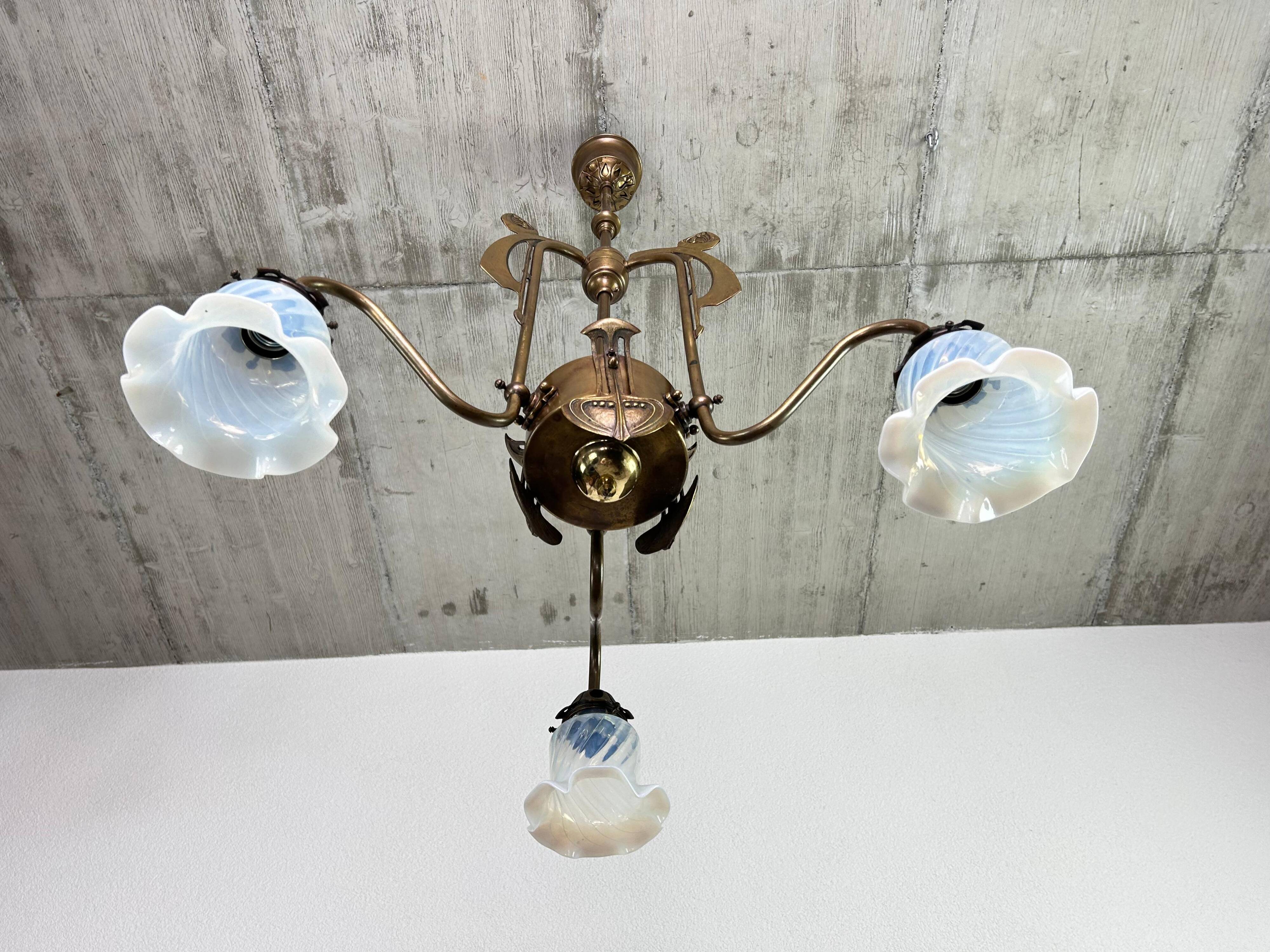 Art Nouveau chandelier with three arms and opalescent iridescent glass.