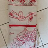 Large white tablecloth and red handmade embroidery. Lace surround;