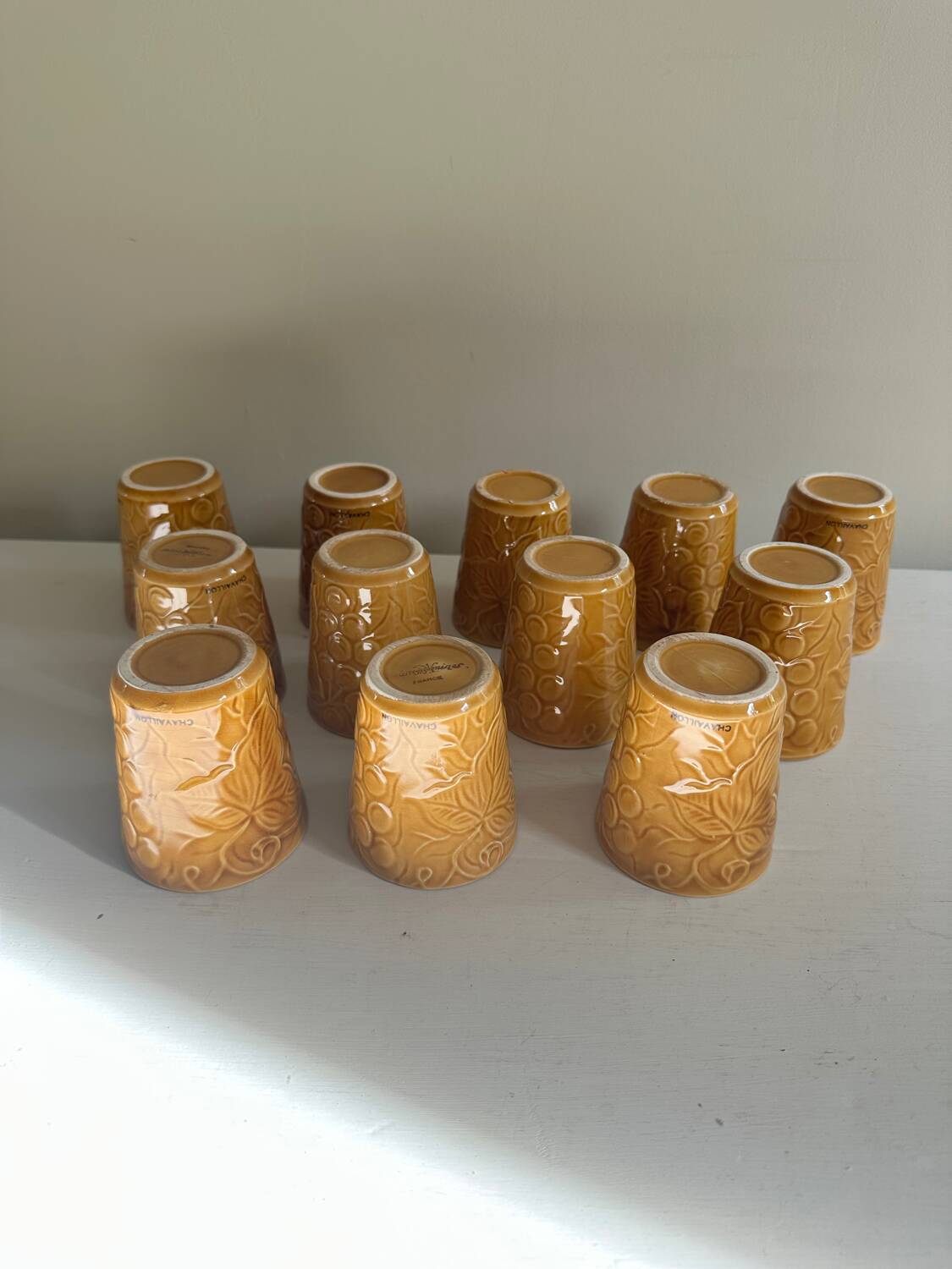 Set of 12 ochre Chavaillon de Sarreguemines cups