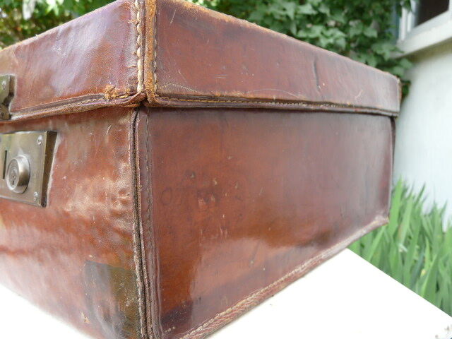 Old monogrammed leather travel suitcase and barony crown