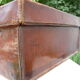Old monogrammed leather travel suitcase and barony crown