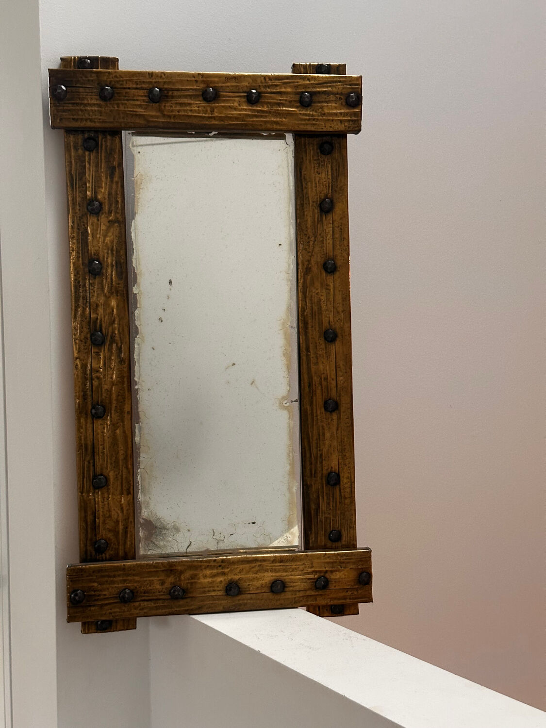 Brutalist mirror with a hammered copper and brass frame.