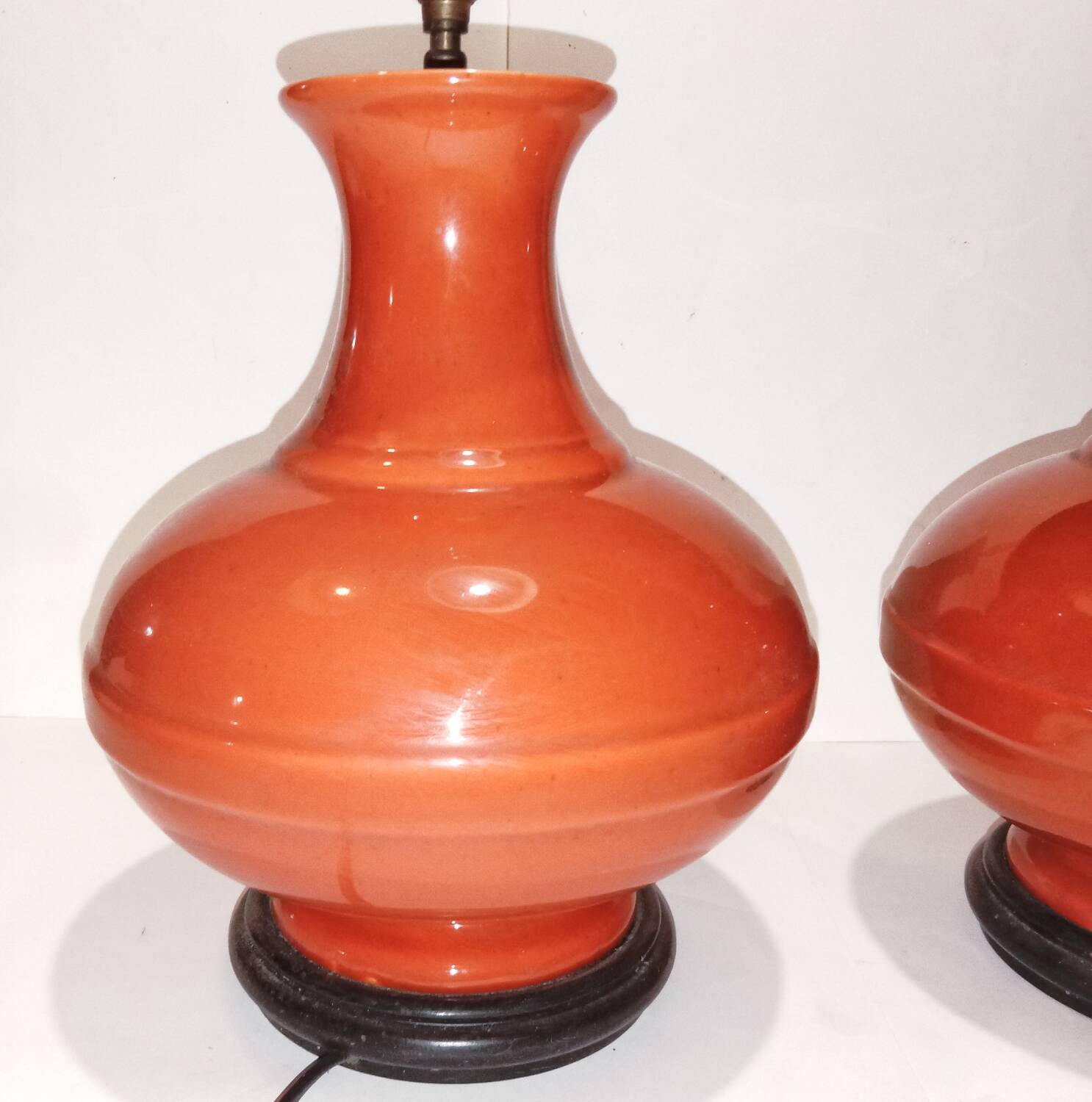 Pair of ceramic lamp bases in the shape of orange gourds.