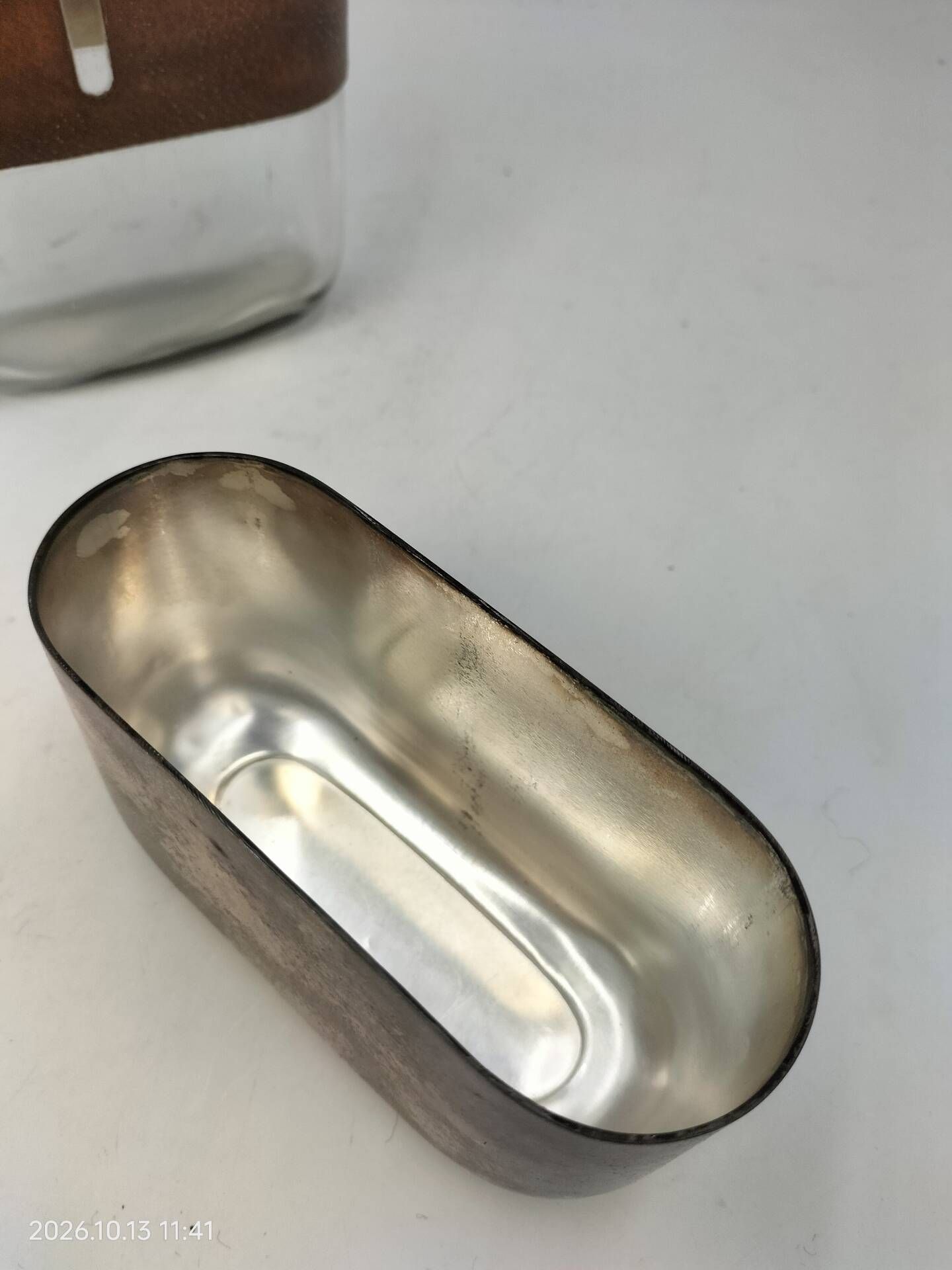 Silver-plated metal flask with leather and glass