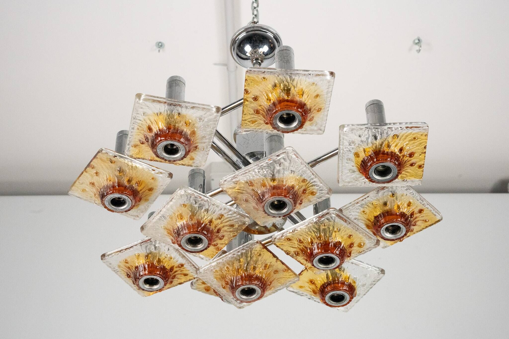 12-light Mazzega chandelier in amber and clear murano glass and chrome. Ita