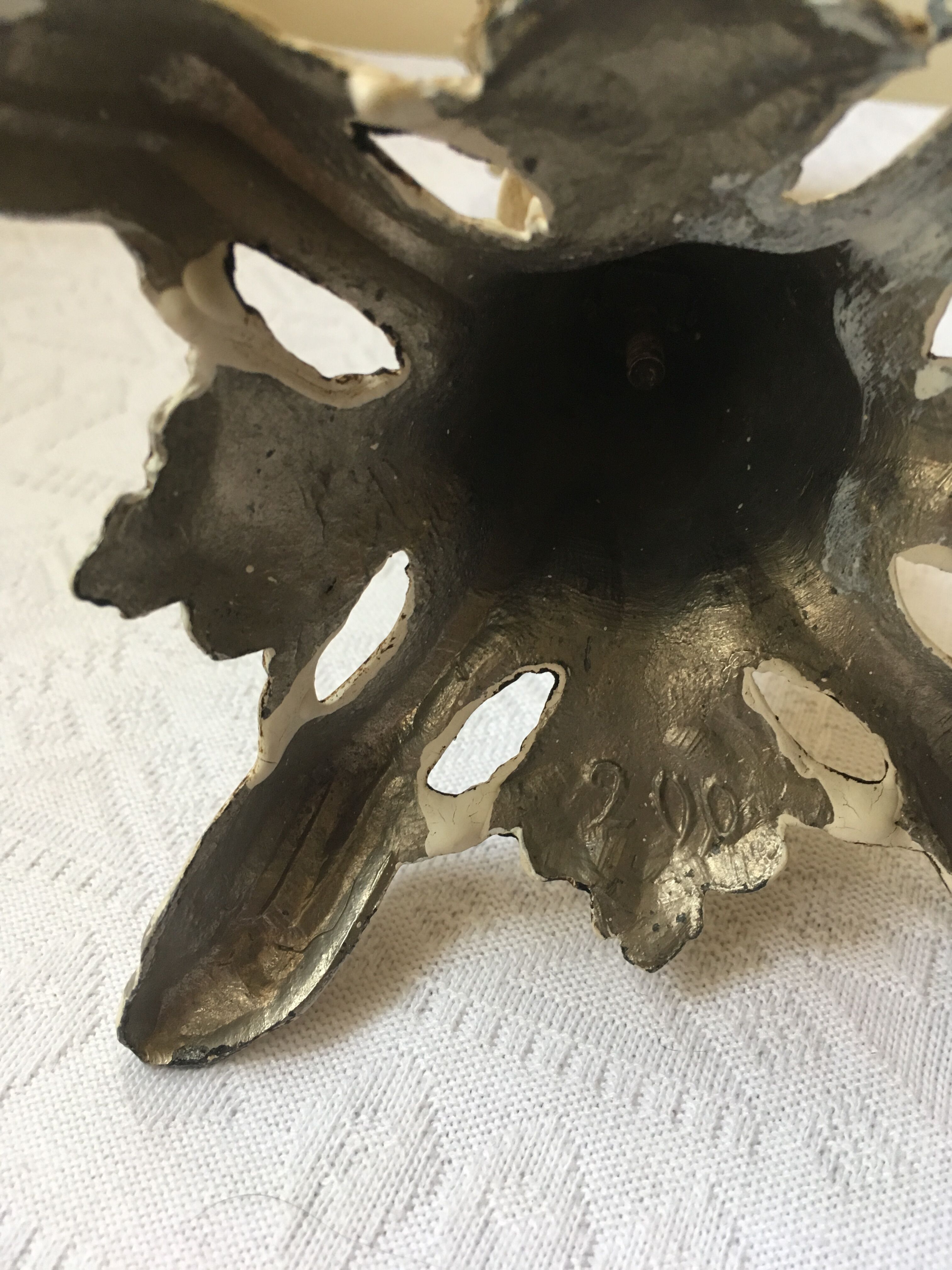 Large candle holder in patinated white painted metal