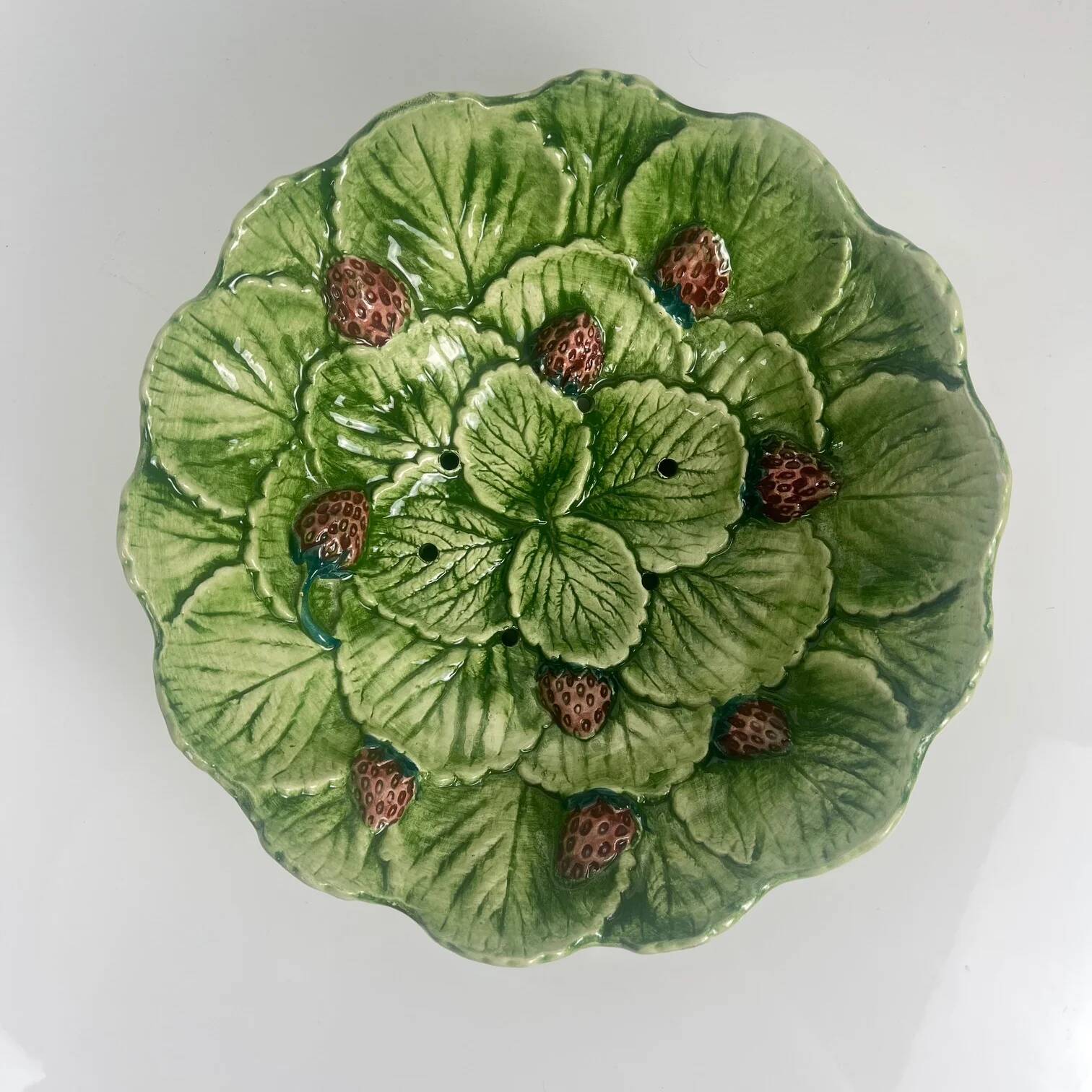 Leaf and strawberry-shaped bowl/strainer.