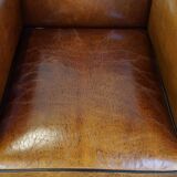 Sheep leather design armchair finished with decorative nails and black piping