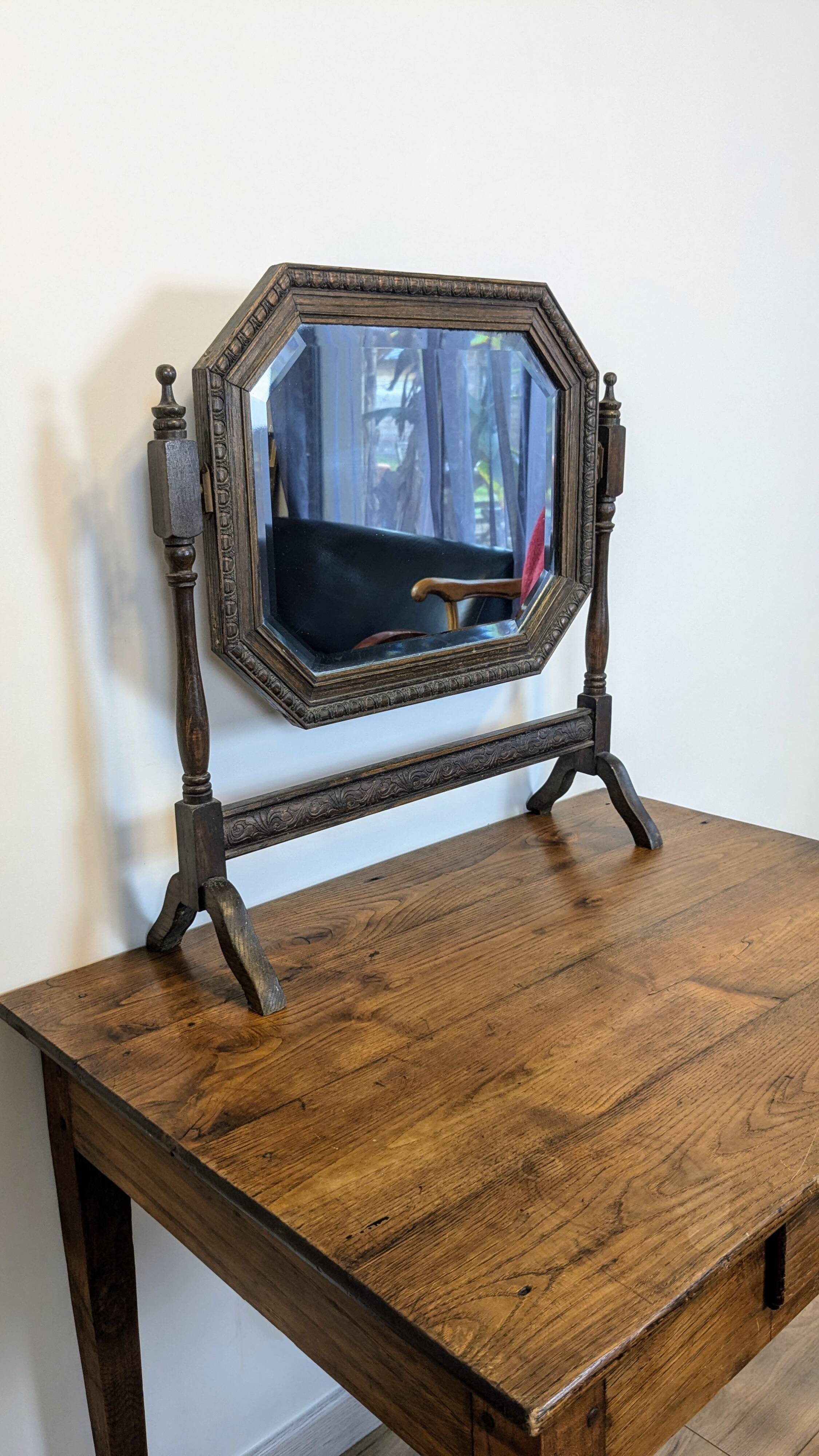 Antique beveled octagonal vanity mirror in carved wood
