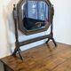 Antique beveled octagonal vanity mirror in carved wood