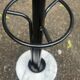 Vintage black metal coat rack with a white marble base.