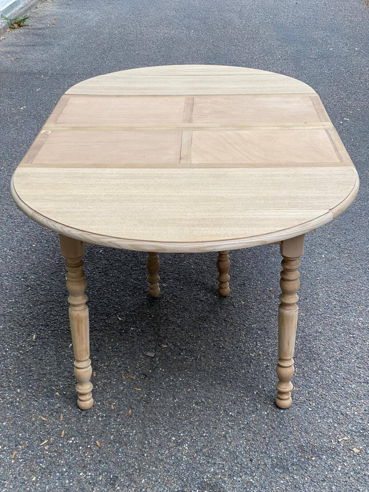 Round dining table with extendable leaves, Louis Philippe style, stripped in raw oak.