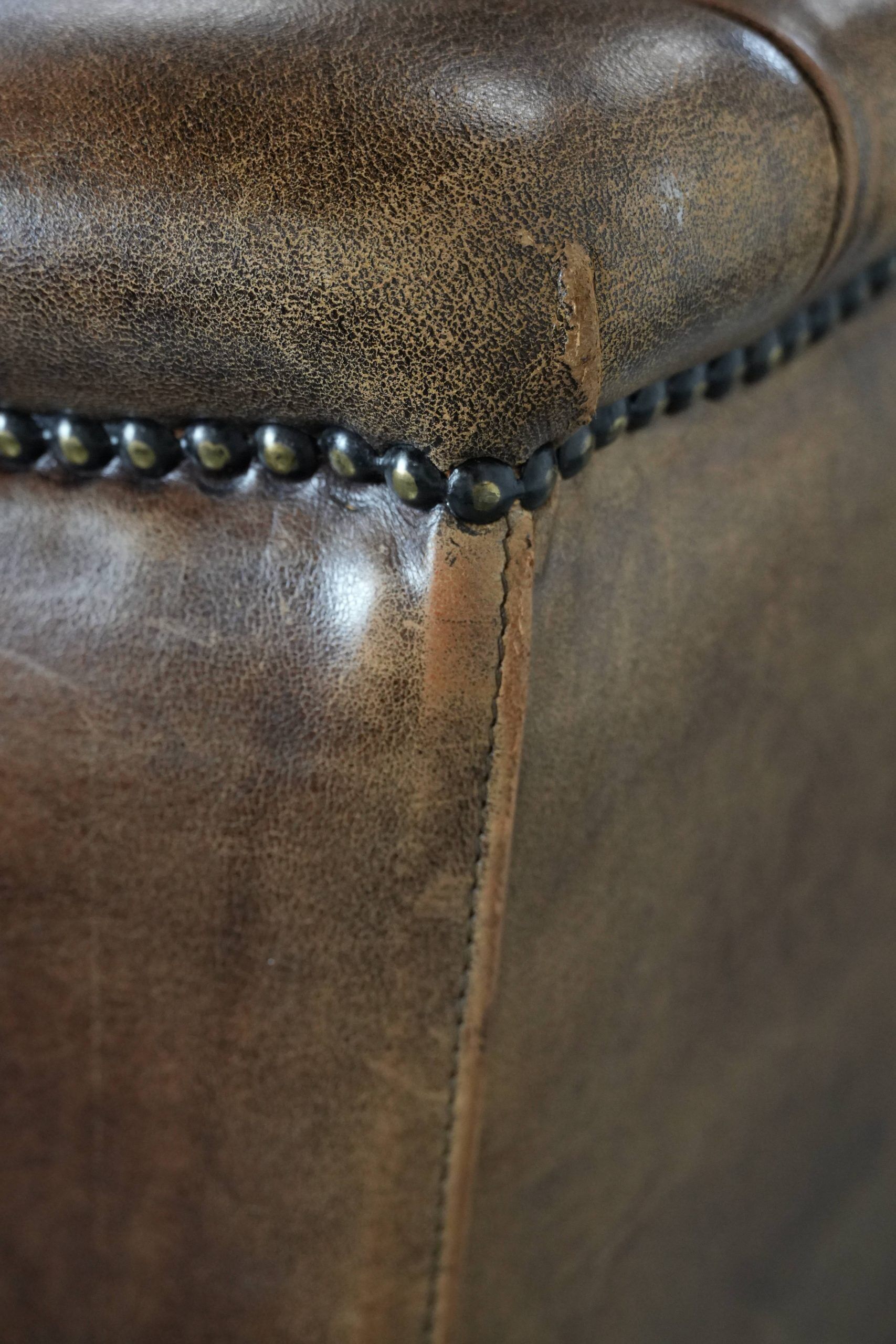 Warm, cosy and comfortable vintage sheepskin ear armchair with character