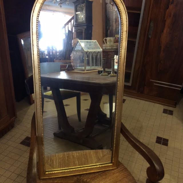 Wooden mirror and gilded stucco