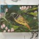 Oil painting still life of a goldfinch.