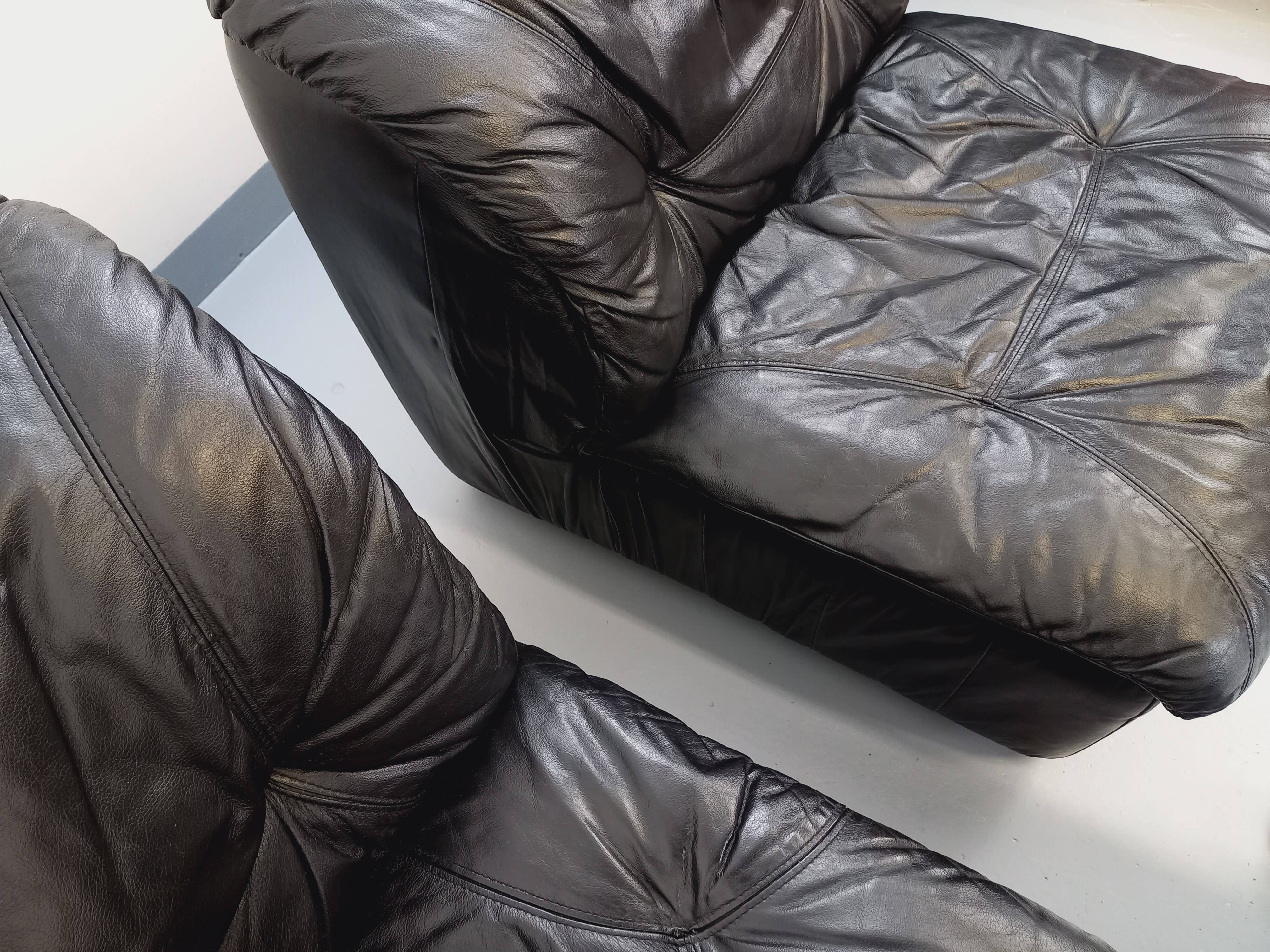 Vintage corner sofa composed of 3 modules in black leather with integrated bed.