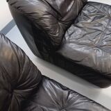 Vintage corner sofa composed of 3 modules in black leather with integrated bed.