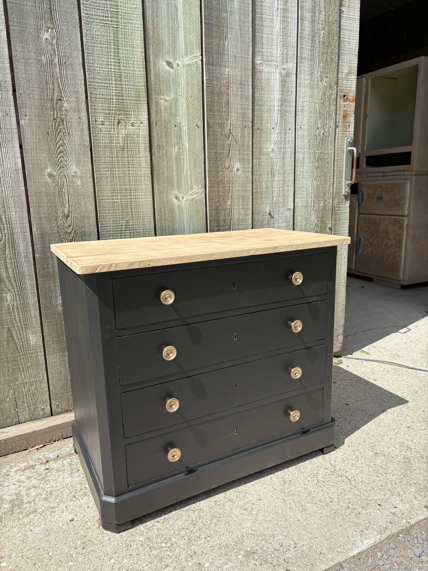 Antique commode with a matte black finish.