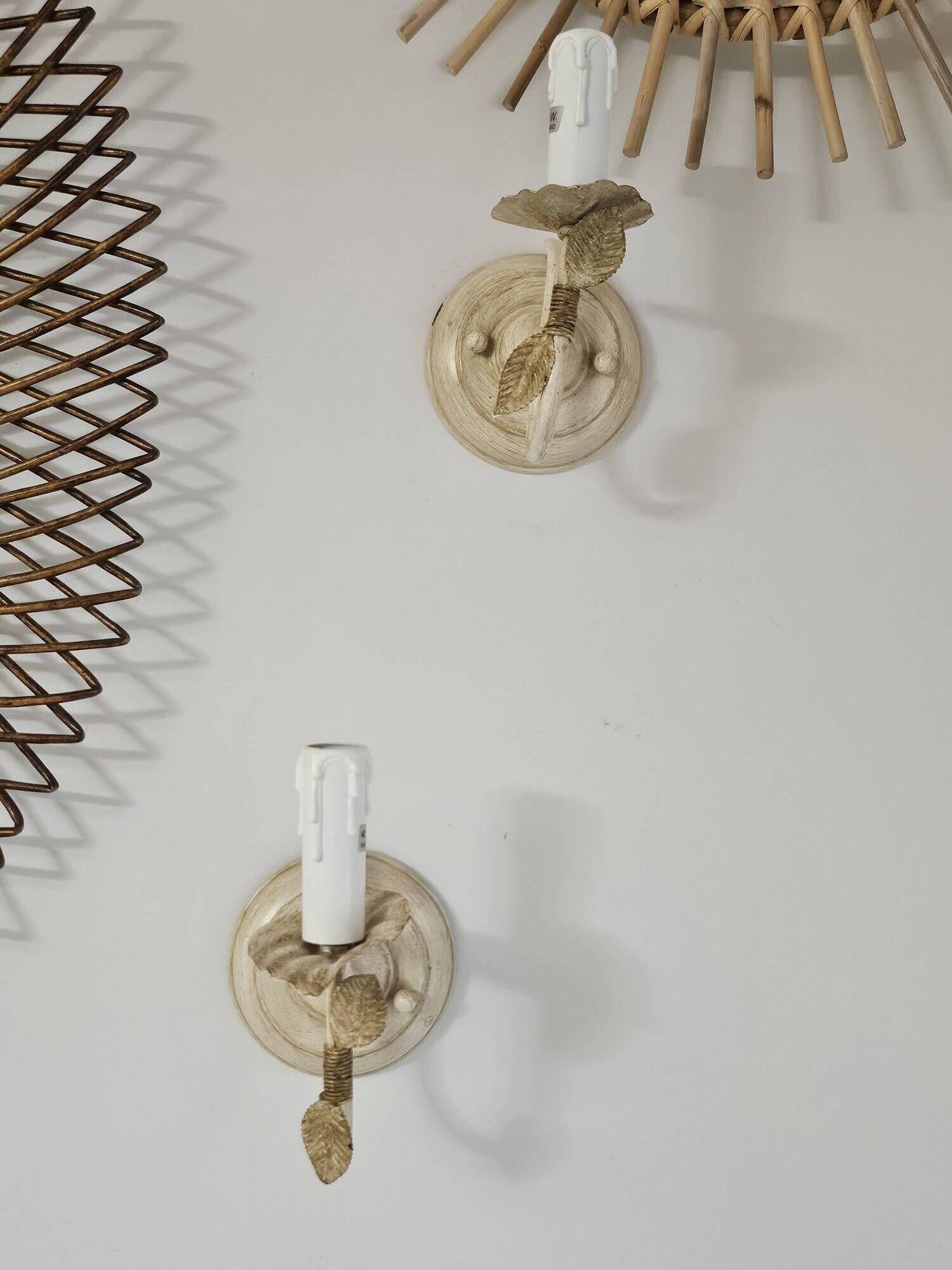 Pair of cream patinated metal wall sconces with floral decoration.