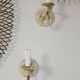 Pair of cream patinated metal wall sconces with floral decoration.