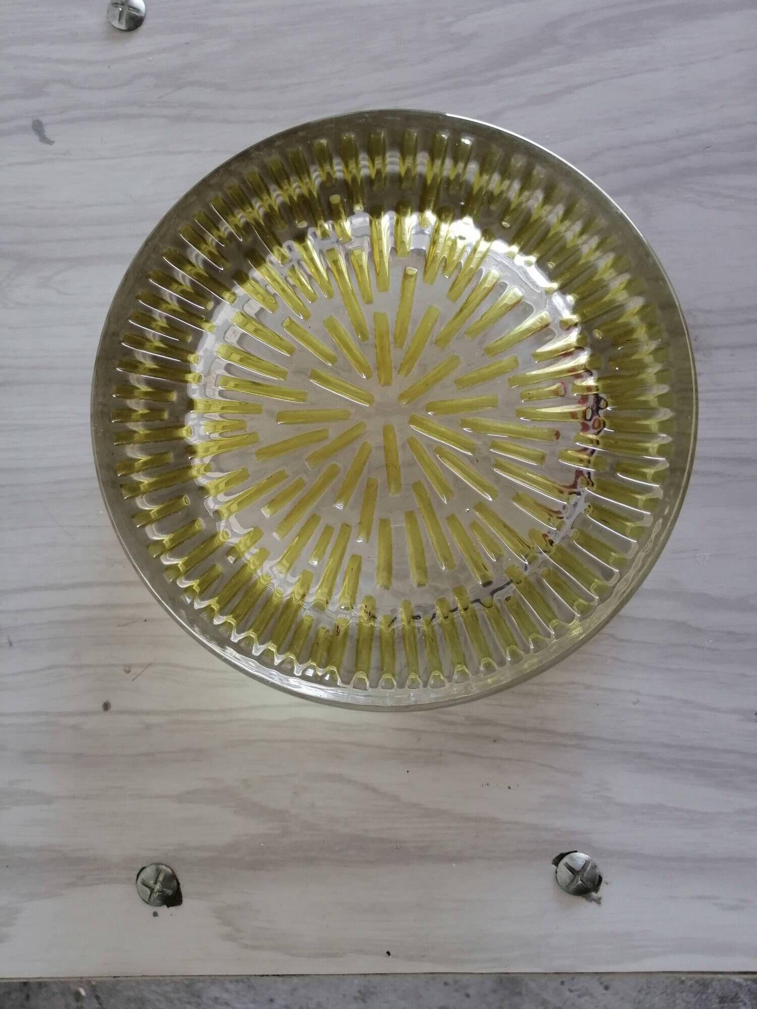 Empty round pockets of iridescent transparent glass of yellow sticks
