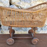 Old rattan cradle on wheels