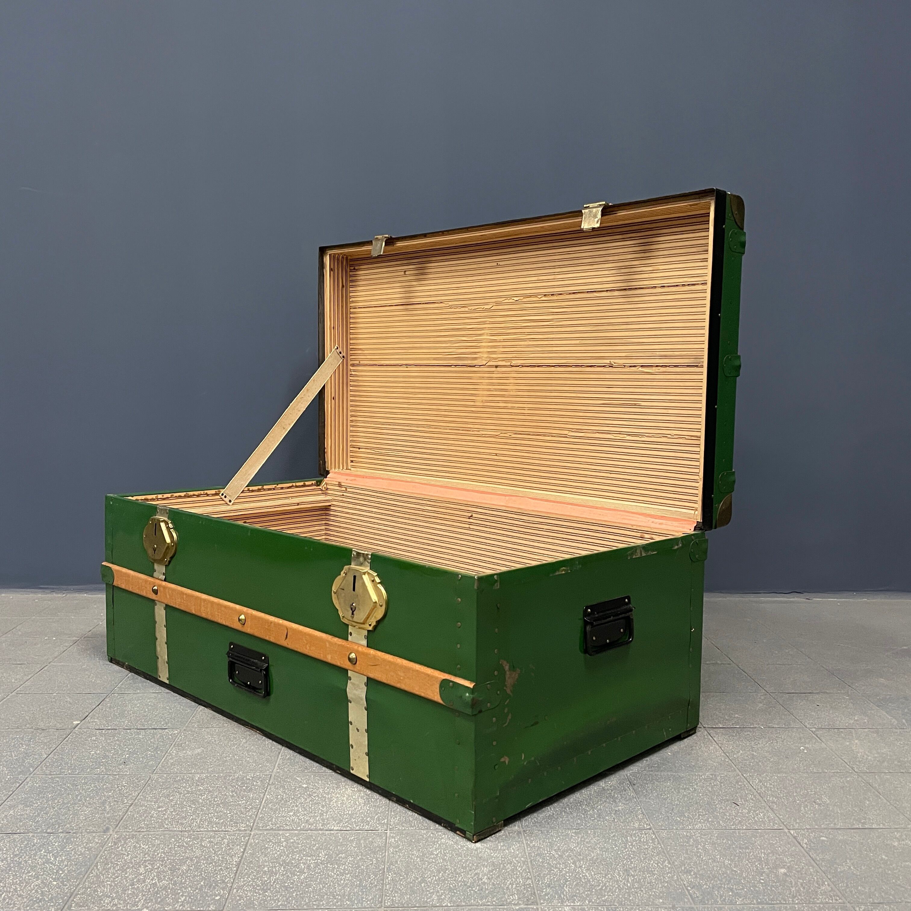 Green metal trunk with wooden sleds
