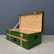 Green metal trunk with wooden sleds