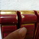 together 12 carries knives and a red enamelled earthenware bottle