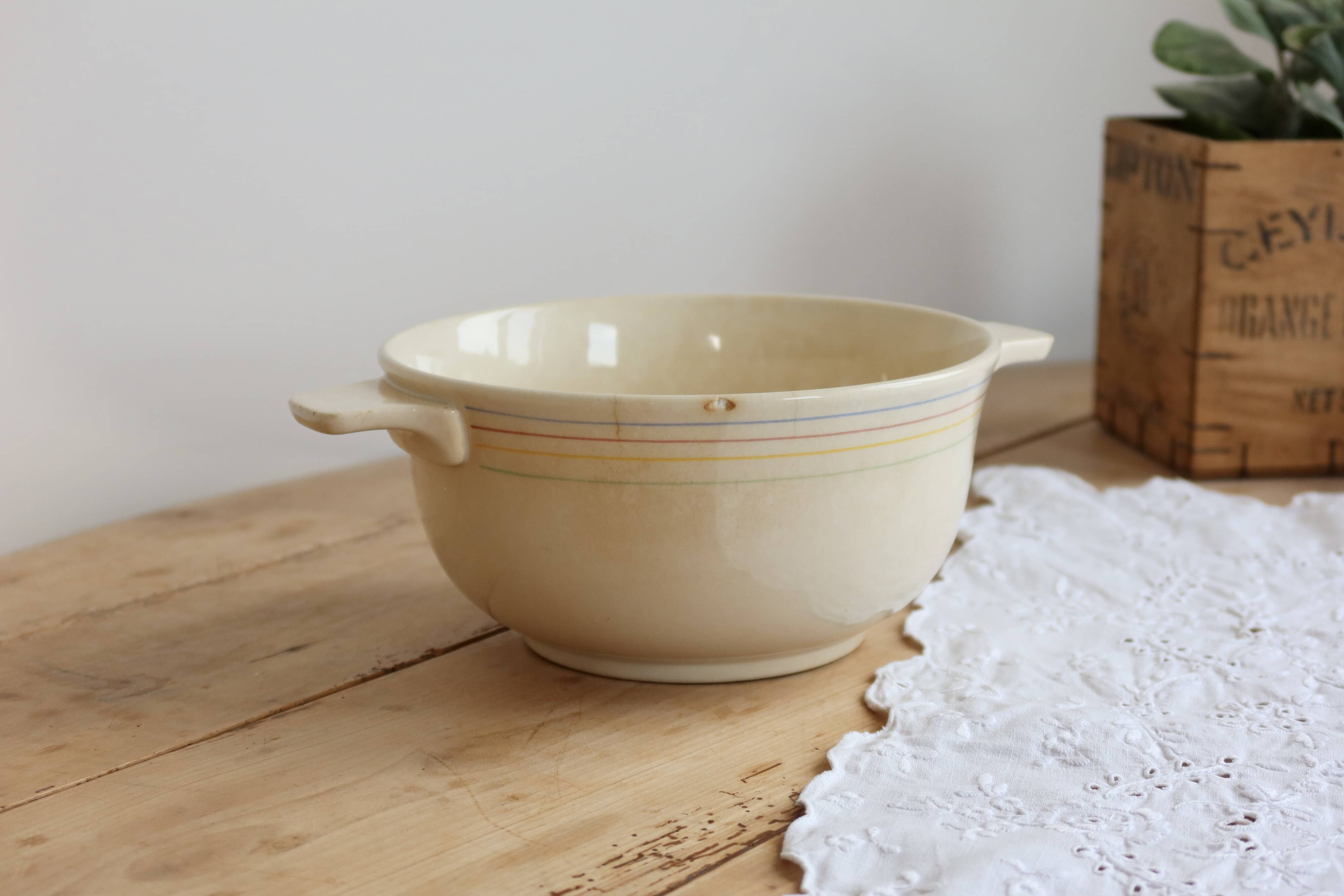 Vintage salad bowl in ivory faience from Chantilly with a rainbow trim.