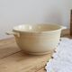 Vintage salad bowl in ivory faience from Chantilly with a rainbow trim.