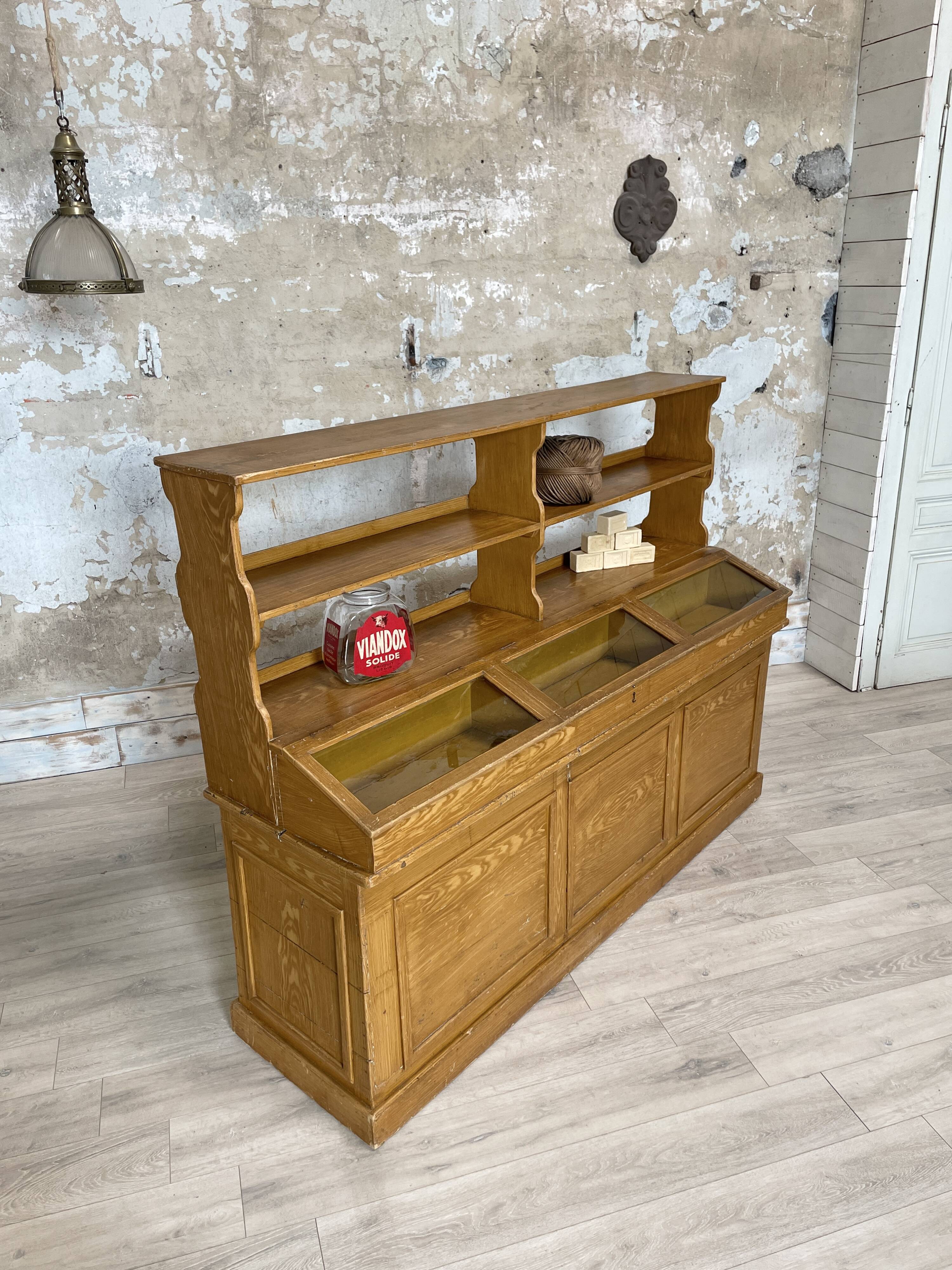 Wooden hardware cabinet painted with wood effect, circa 1940.